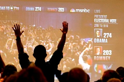 Arizona Democrats celebrate as President Barack Obama is declared the winner of the presidential race at Democratic Party gathering in Tucson, Ariz.(AP Photo/Ross D. Franklin)