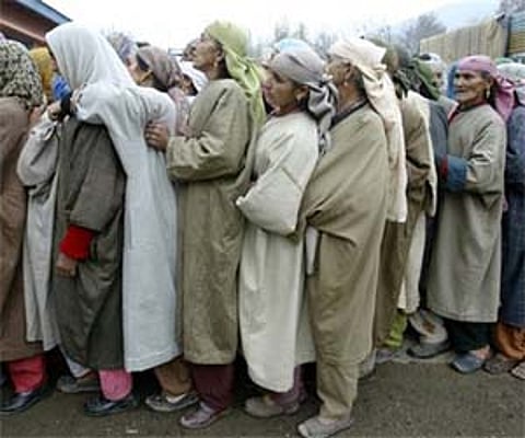 Kashmiri Muslim women wait to cast their vote outside a polling station in Bandipora. AP