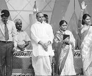 Brother Anil Kumar (left) preaching praying at the Festival of Jesus Christ at parade Grounds in Secunderabad on Sunday. Chief Minister YS Rajasekhara