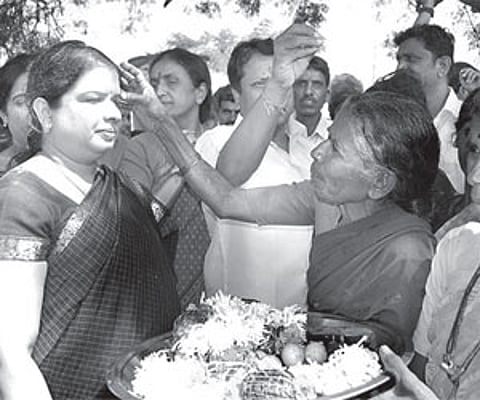 Women applying vermilion on the forehead of Anita Kumaraswamy while campaigning in a village in Madhugiri assembly constituency on Sunday.