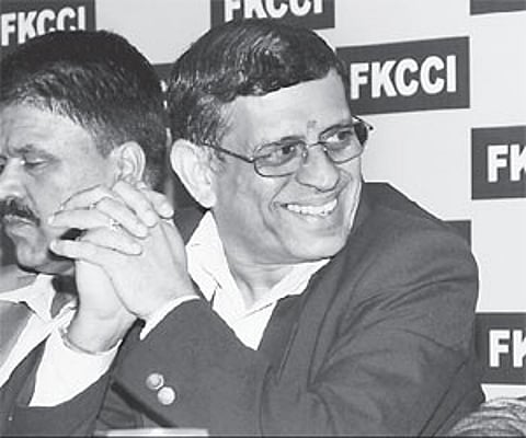 Columnist S Gurumurthy at a talk on 'global financial crisis-Impact on India, in Bangalore on Tuesday. FKCCI president D Muralidhar and vice-presiden