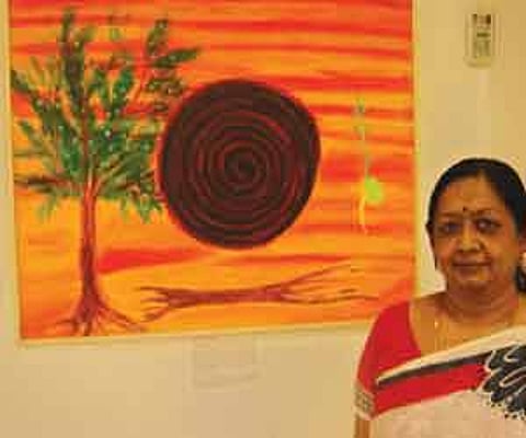 Artist Dr. Shoba Ramakrishnan with one of her paintings/Pix: Swahilya