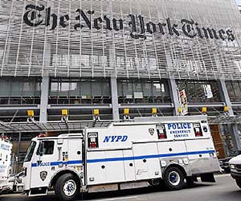 New York City police vehicles are seen outside the New York Times headquarters building in New York in this October 22, 2008 (File photo / Reuters)