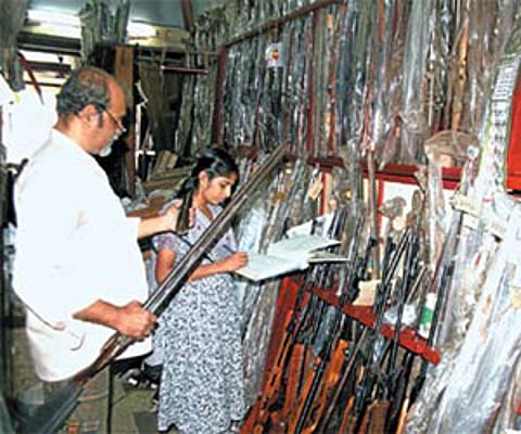 Cochin Armoury proprietor Sajan K Poulose recording the details of the guns deposited at his armoury by licensees/P K Jeevan Jose.