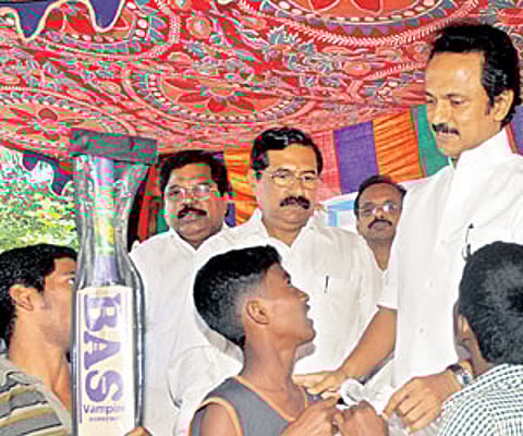 Deputy Chief Minister M K Stalin interacting with kids at the Puzhal Lankan refugee camp on Saturday.