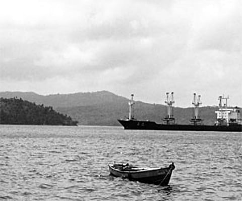 A police marine boat of the Andaman and Nicobar Police guarding the North Korean ship (R) detained at Port Blair for unauthorised anchoring off the An