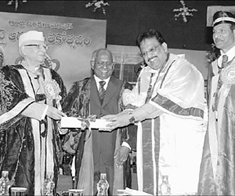 Chancellor of Andhra University and Governor of Andhra Pradesh N D Tiwari presenting the ‘Kala Prapurna’ to noted playback singer S P Balasubramanyam