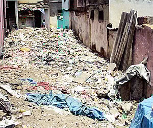Garbage left uncleared has made Someshwaranagar slum an inhospitable place for the residents.