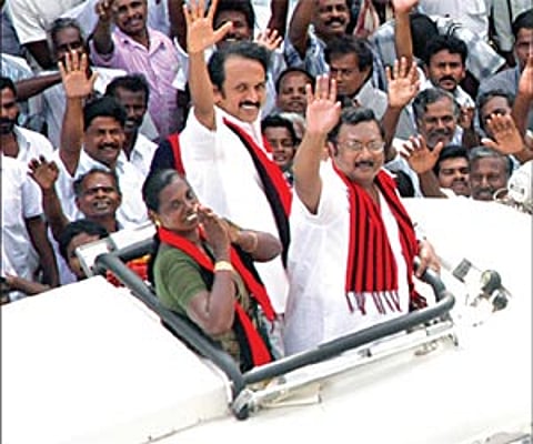 Local Administration Minister M K Stalin, his brother M K Azhagiri and DMK candidate Latha Adhiyaman, waving to the crowd from an open vehicle in Thir