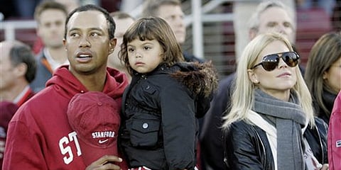 A file photo of Tiger Woods with his daughter, Sam, and wife Elin: AP Photo