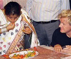 Anandita Dutta Tamuly, left, gobbles up ghost chilis, the world’s spiciest chili, during an attempt to enter the Guinness Book of World Records. AP