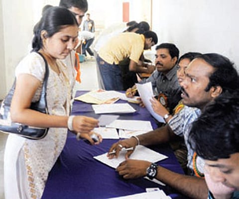 Young women queue up to fill application forms at the event.