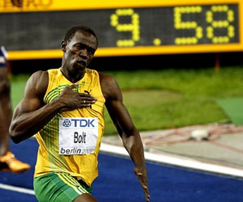 Jamaica's Usain Bolt celebrates setting a new Men's 100m World Record at the World Athletics Championships in Berlin on Sunday. (AP)