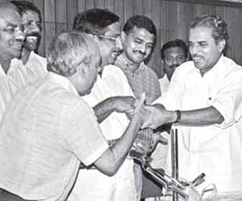 Sports Minister M Vijayakumar presenting the cash prize of Rs 25 lakh to the officials of the Viva Kerala Football Club at a function in Kochi on Thur