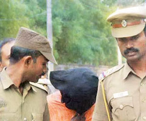 Psychopath Kuppusamy, being taken away by police.