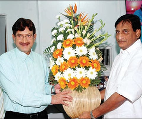 Film producer and brother G Adiseshagiri Rao presenting a bouquet to actor Krishna in Hyderabad on Sunday.