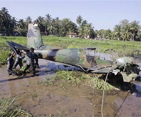 Sri Lankan air force officers lift the wreckage of an aircraft used by the Tamil Tiger rebels to launch an attack at Colombo (AP)