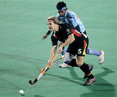 India's Arjun Halappa and Germany's Jannik Otto, front, vie for the ball during the four nation hockey tournament (Photo: AP)