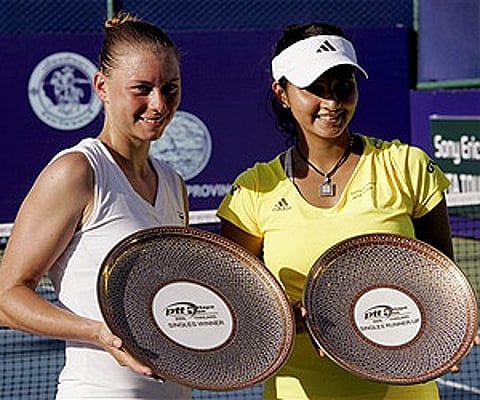 Vera Zvonareva and Sania Mirza pose with their trophies after the final match of the Pattaya Open tennis tournament in Thailand Sunday. (Photo: AP)