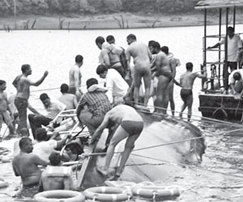 Rescuers carrying out their task at the mishap site in the Thekkady lake. Seen sunk is `Jalakanyaka’, the double-decker passenger boat of the KTDC.