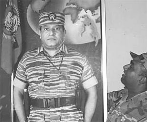 BEFORE THE FALL: The file photo shows a Sri Lankan soldier looking at the portrait of LTTE supremo Prabhakaran at a Black Tigers’ camp in Mullaitivu.