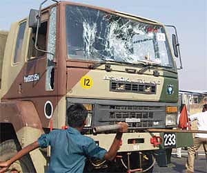 Members of PDK and MDMK damaging military vehicles on Neelambur bypass on Saturday. Suspecting that Indian Army was carrying arms to be supplied to Sr
