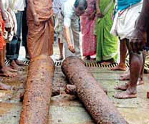 Archaeological documentation officer Balamohanan examining the two cannons excavated from the Perumthatta Siva temple at Guruvayur on Thursday.