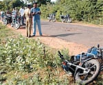 History-sheeter Senthilvelavan’s motorcycle lies in the foreground at the site of the encounter at Ganapathy Koil in Vengur near Tiruchy on Friday.