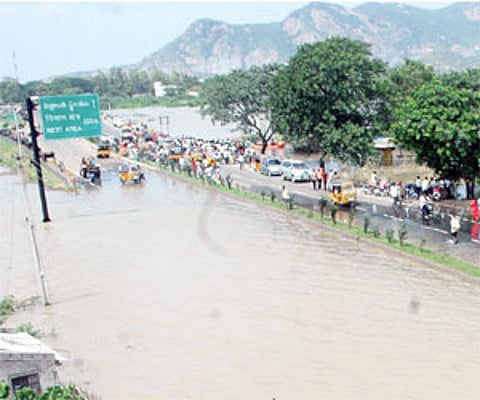 National highway No 9 submerged in flood waters at Mulapadu in Krishna district on Monday/Ch Narayana Rao .