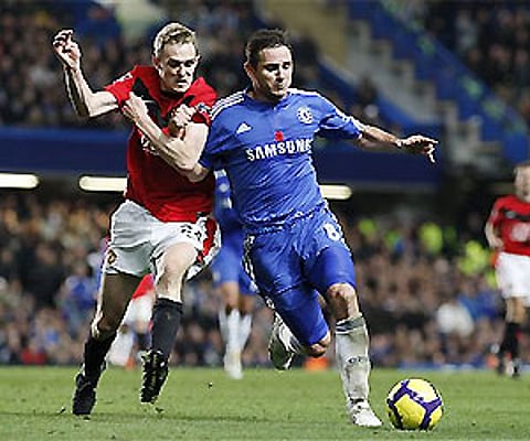 Chelsea's Frank Lampard, right, tussles with Manchester United's Darren Fletcher during their English Premier League match at Stamford Bridge. AP