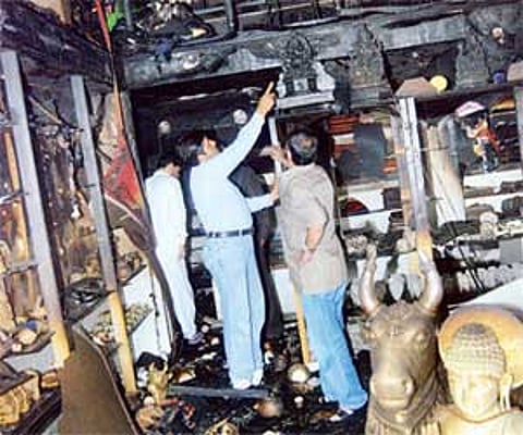 Officials inspecting Cauvery Industries Exhibits which was gutted in a fire mishap, at Trinity Circle.