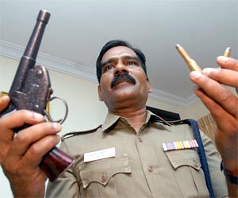 Mylapore Deputy CoP A G Mourya displaying the gun and bullets recovered from ‘CD’ Mani (center) in the city on Tuesday.