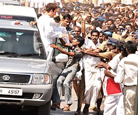 Hanging on: Breaking the security barricade, a boy hangs on to AICC General Secretary Rahul Gandhi’s car in Thanjavur on Wednesday.