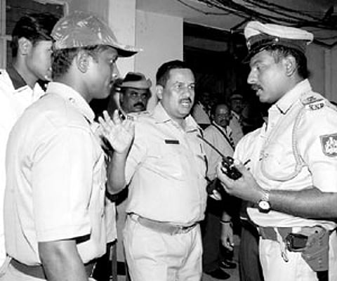 Police officials discuss the bomb scare at the Chinnaswamy Stadium, in Bangalore on Saturday.