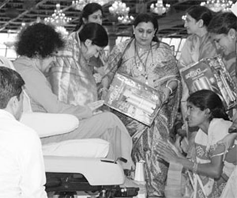 Sri Satya Sai Baba distributing water filters to poor women in Puttaparthi on Thursday.