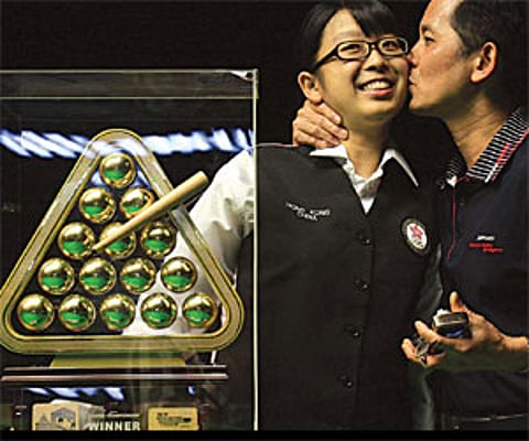 Ng On Yee is kissed by her father Ng Yam Shui after winning the title in Hyderabad on Tuesday/A Suresh Kumar.