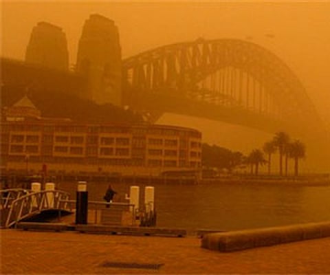 An almost unseen Sydney Harbour Bridge during a dust storm September 23, in Sydney. (AP)