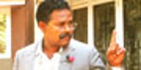 Innocent and wife Alice standing next to the wax statue of American comedian Eddie Murphy at the Madame Tussaud’s Museum in London.