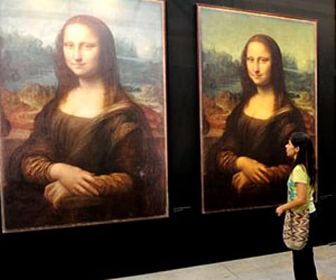 A visitor looks at replicas of Leonardo da Vinci's Mona Lisa at the "Da Vinci The Genius" exhibition in Medellin, Colombia. (AP File Photo)