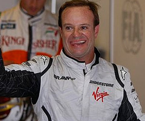 Rubens Barrichello celebrates after winning the pole position at the Interlagos race track in Sao Paulo. (Photo: AP)