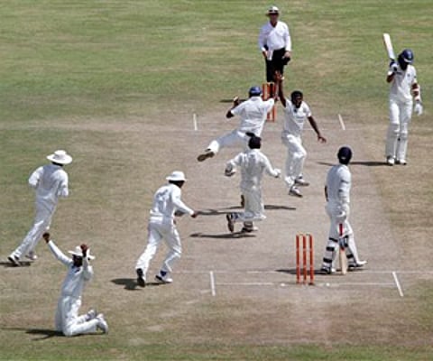 Lankan cricketer Muttiah Muralitharan facing camera jumps after he claimed his 800th Test wicket in the first cricket Test against India. (AP)