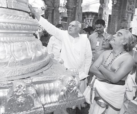 Chief minister K Rosaiah praying at the dwajasthambam in Tirumala temple on Wednesday. (EPS)