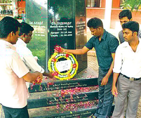 TNAU staff at a memorial set up in memory of the victims.