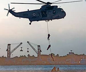 Marine commandos demonstrating a special operation of slithering from a Seaking 42 Charley helicopter as a part of an operational demonstration organi