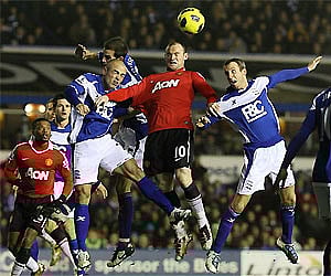 Manchester United's Wayne Rooney, centre, Birmingham's Lee Bowyer, right, and Stephen Carr battle for the ball during the English Premier League. AP