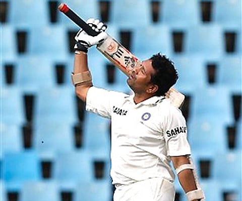 India's batsman Sachin Tendulkar looks up as he celebrates his century during the fourth day of the first cricket test match against South Africa. AP