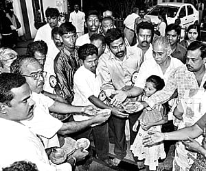 61 AND STILL ROCKING: Rajini’s fans distributing prasadam at TTD Devasthanam on his birthday in the city on Sunday.