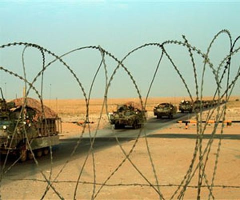 A column of US Army Stryker armored vehicles cross the border from Iraq into Kuwait.