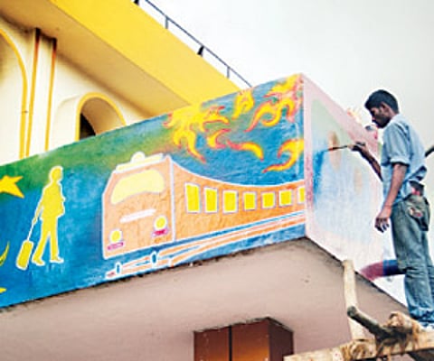 An artist working at the Cantonment Railway Station. The station will soon sport paintings depicting scenes from a railway station| Suresh Nampoothiri