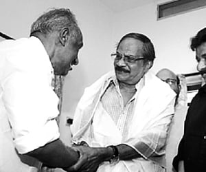 Cultural Affairs Minister K C Joseph congratulating M T Vasudevan Nair, who has been selected for this year’s Ezhuthachan Puraskaram, at his residenc